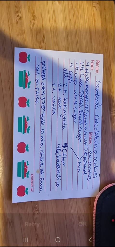 Photo of a handwritten recipe card for chocolate chip cookies with ingredients, yield, and baking notes